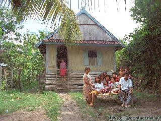 [Pic: Family at home in Dompu] 